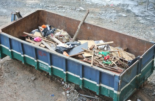 Crew of waste removal workers in high-visibility gear at a Camden commercial site