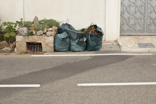 Workers wearing PPE handling segregated waste containers